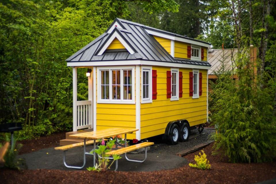 <p>Just one of the homes in Oregon's Mt. Hood Tiny House Village, "Savannah" features yellow cedar plank siding with red shutters and white trim. So welcoming!</p><p><a class="link " href="https://go.redirectingat.com?id=74968X1596630&url=https%3A%2F%2Fwww.tripadvisor.com%2FShowUserReviews-g52127-d909607-r464373430-Mt_Hood_Village_RV_Resort-Welches_Clackamas_County_Oregon.html&sref=https%3A%2F%2Fwww.countryliving.com%2Fhome-design%2Fg1887%2Ftiny-house%2F" rel="nofollow noopener" target="_blank" data-ylk="slk:PLAN YOUR TRIP;elm:context_link;itc:0;sec:content-canvas">PLAN YOUR TRIP</a> <a class="link " href="https://www.countryliving.com/life/travel/g3595/tour-tiny-house-village/" rel="nofollow noopener" target="_blank" data-ylk="slk:SEE INSIDE;elm:context_link;itc:0;sec:content-canvas">SEE INSIDE</a><br></p>