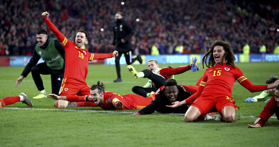 Wales' Aaron Ramsey (10), Gareth Bale, centre, and Ethan Ampadu (15) celebrate victory against Hungary, during their UEFA Euro 2020 Qualifying soccer match at the Cardiff City Stadium, in Cardiff, Wales, Tuesday Nov. 19, 2019. (Nick Potts/PA via AP)