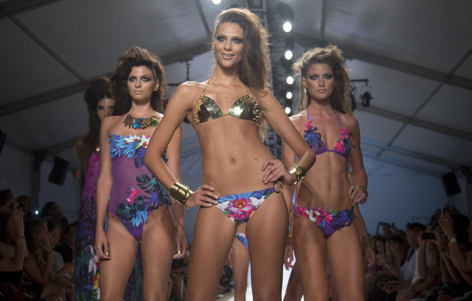 In this Friday, July 19, 2013 photo, a models walk the runway during the Dolores Cortes show at the Mercedes-Benz Fashion Week Swim show in Miami Beach, Fla. (AP Photo/J Pat Carter)