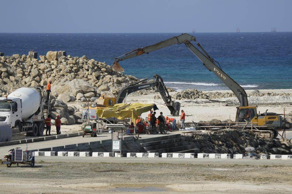 Construction continues at the Philippine-occupied Thitu island, locally called Pag-asa island, on Friday, Dec. 1, 2023 at the disputed South China Sea. The Philippine coast guard inaugurated a new monitoring base Friday on a remote island occupied by Filipino forces in the disputed South China Sea as Manila ramps up efforts to counter China's increasingly aggressive actions in the strategic waterway. (AP Photo/Aaron Favila)