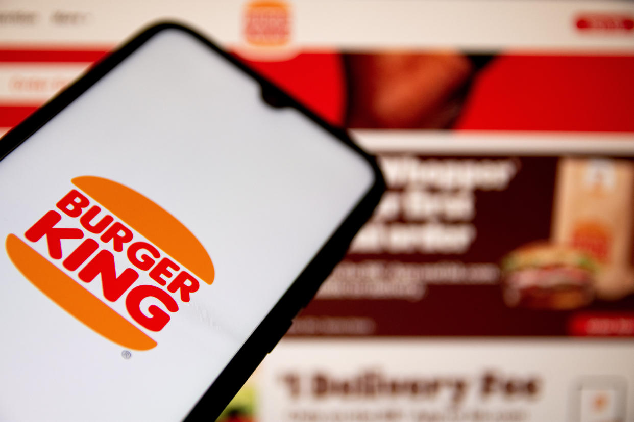 GREECE - 2021/05/07: In this photo illustration a Burger King logo seen displayed on a smartphone screen with Burger King website in the background. (Photo Illustration by Nikolas Joao Kokovlis/SOPA Images/LightRocket via Getty Images)