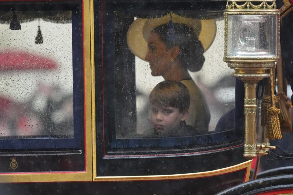 The Princess of Wales and Prince Louis safely in the carriage as they proceed along the rain-soaked Mall (James Manning/PA Wire)