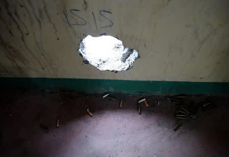 Empty shells and cigarette butts are seen under a hole where snipers from the pro-Islamic State militant groups used to position themselves inside a house in the war-torn Marawi city, southern Philippines October 19, 2017. REUTERS/Romeo Ranoco