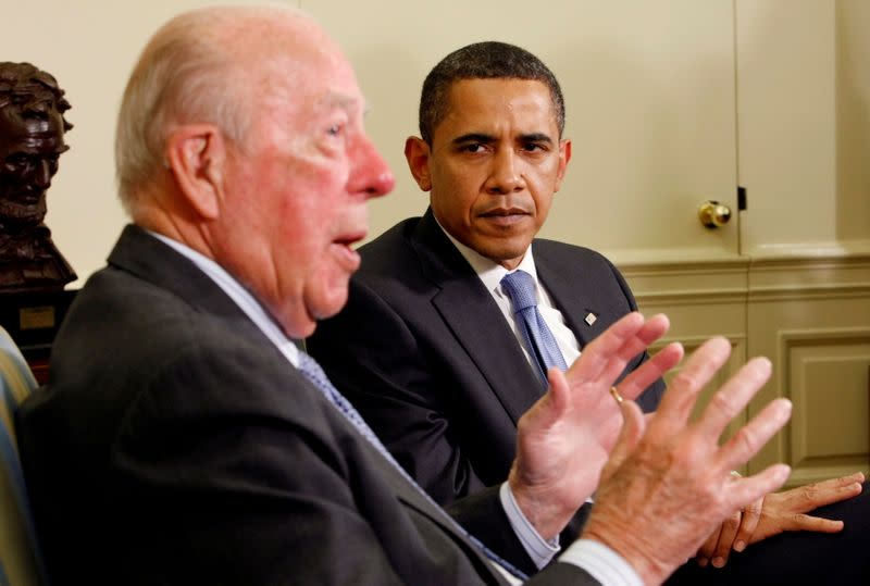 FILE PHOTO: U.S. President Barack Obama listens as former U.S. Secretary of State George Shultz speaks in the Oval Office of the White House in Washington