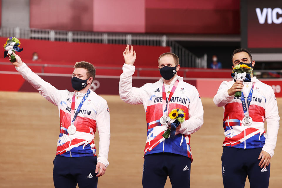 Tokyo 2020 Olympics - Cycling - Track - Men's Team Sprint - Medal Ceremony - Izu Velodrome, Shizuoka, Japan - August 3, 2021.  Silver medallists Ryan Owens of Britain, Jack Carlin of Britain and Jason Kenny of Britain celebrate on the podium. REUTERS/Kacper Pempel