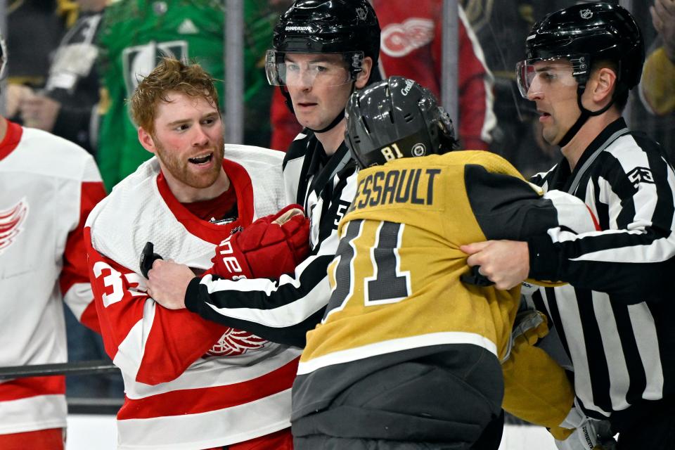 Officials break up a fight between Detroit Red Wings left wing J.T. Compher (37) an Vegas Golden Knights right wing Jonathan Marchessault (81) during the second period at T-Mobile Arena in Las Vegas on Saturday, March 9, 2024.