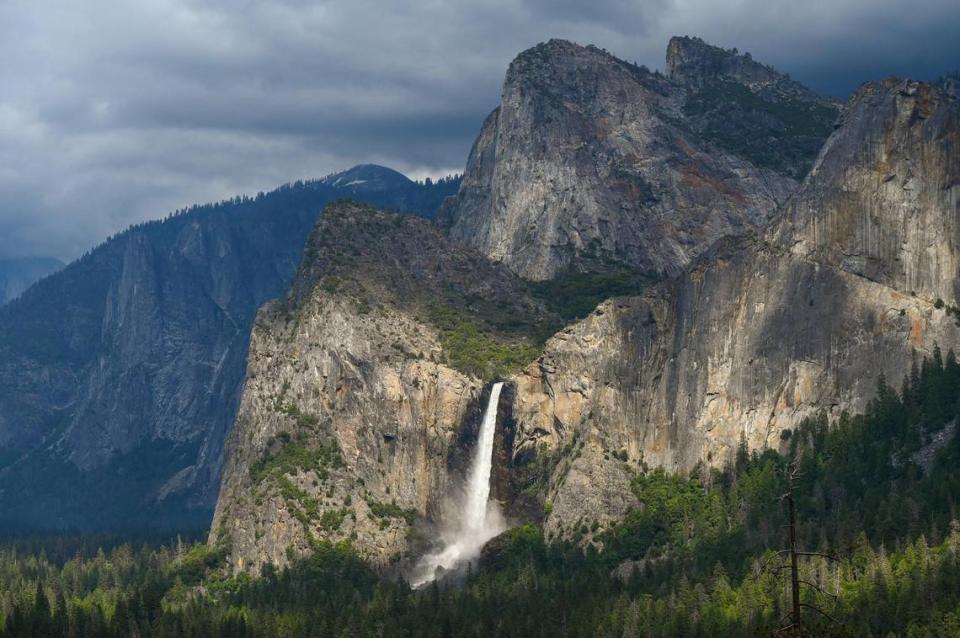 Bridalveil Fall gleams in the late afternoon sunlight as clouds form overhead in Yosemite Valley on Tuesday, June 13, 2023. CRAIG KOHLRUSS/ckohlruss@fresnobee.com