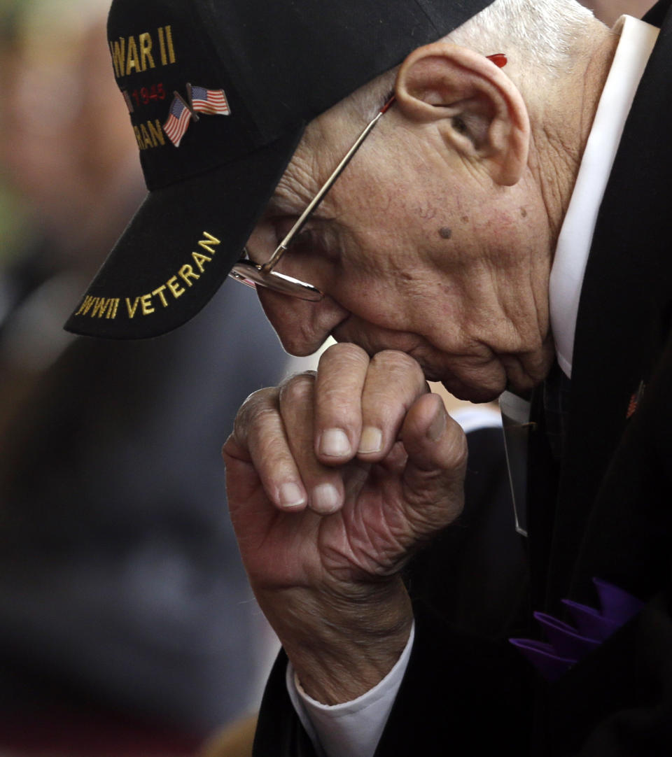 World War II veteran Michael Sgaglione of Middle Island, N.Y., listens to a speaker before receiving the insignia of the French Legion of Honor during a ceremony at the U.S. Military Academy, on Friday, May 9, 2014, in West Point, N.Y. Thirty-four U.S. veterans were honored 70 years after the D-Day landings. (AP Photo/Mike Groll)