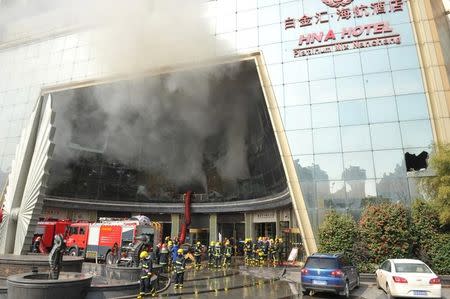 Firefighters are seen at the site after a fire broke out at HNA Hotel in Nanchang, Jiangxi province, February 25, 2017. REUTERS/Stringer