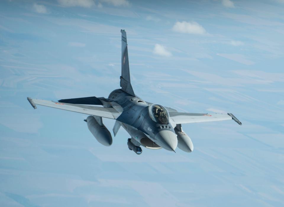 A Romanian Air Force F-16 waits to be fueled from a KC-135 Stratotanker from the 100th Air Refueling Wing, RAF Mildenhall, England, over Romania, in 2018. <em>U.S. Air Force photo by Tech. Sgt. Emerson Nuñez</em>