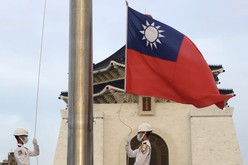 FILE - Two soldiers lower the national flag during the daily flag ceremony on Liberty Square of the Chiang Kai-shek Memorial Hall in Taipei, Taiwan, July 30, 2022. (Chiang Ying-ying/AP, File)<cite class="op-small">Chiang Ying-ying</cite>