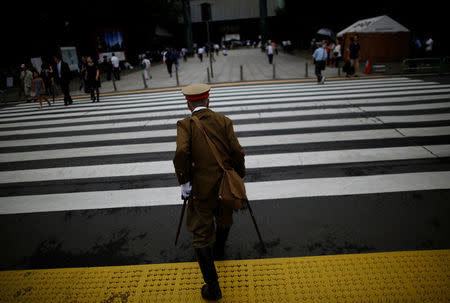 A man dressed as a Japanese imperial army soldier stands at Yasukuni Shrine in Tokyo, Japan August 15, 2017, to mark the 72nd anniversary of Japan's surrender in World War Two. REUTERS/Issei Kato