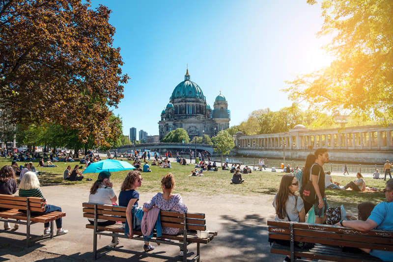 n, Germany - April, 2019: People in public park on a sunny day near Museum Island and Berlin Cathedral