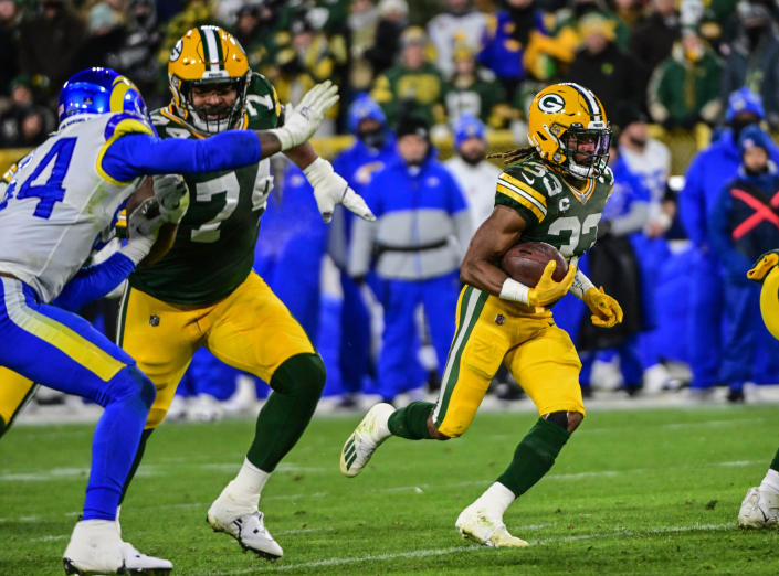 Christian Watson’s block escorts Aaron Jones into end zone vs. Rams