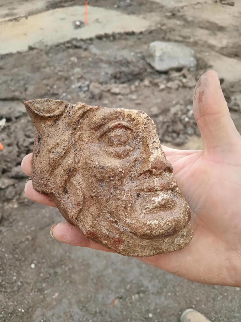 The stone face of a deity found at the site.