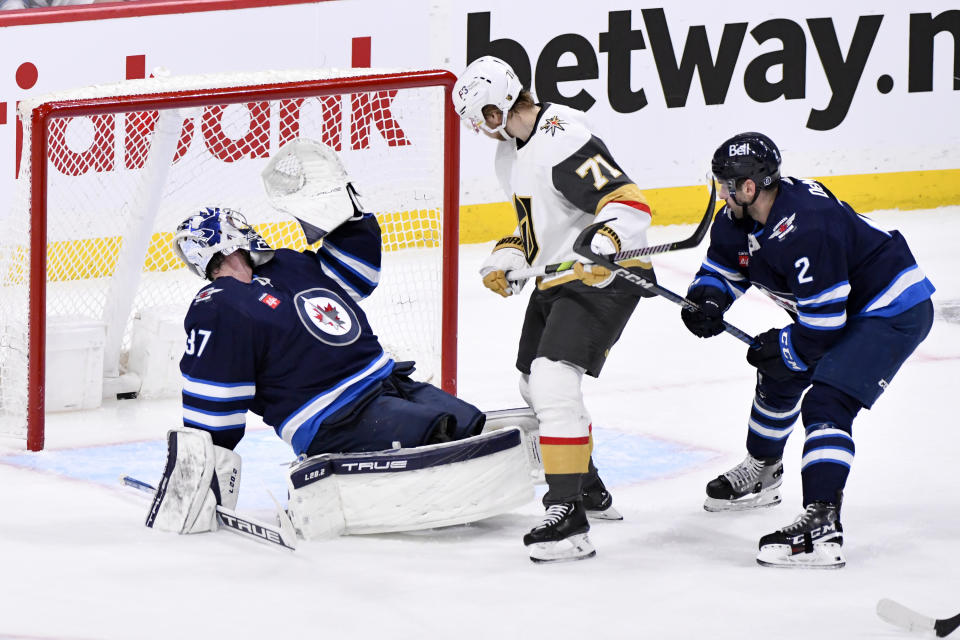 Vegas Golden Knights' William Karlsson (71) scores against Winnipeg Jets' goaltender Connor Hellebuyck (37) during second-period Game 4 NHL Stanley Cup first-round hockey playoff action in Winnipeg, Manitoba, Monday April 24, 2023. (Fred Greenslade/The Canadian Press via AP)