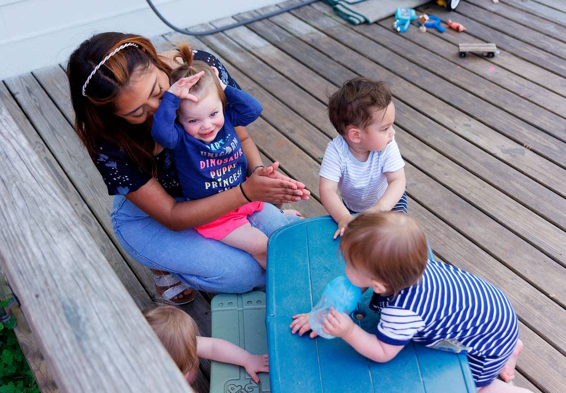 Roxanna Campos-Sosa, a teacher at the Little School of Hillsborough, plays outside with children onz Thursday, April 18, 2024, in Hillsborough, N.C.