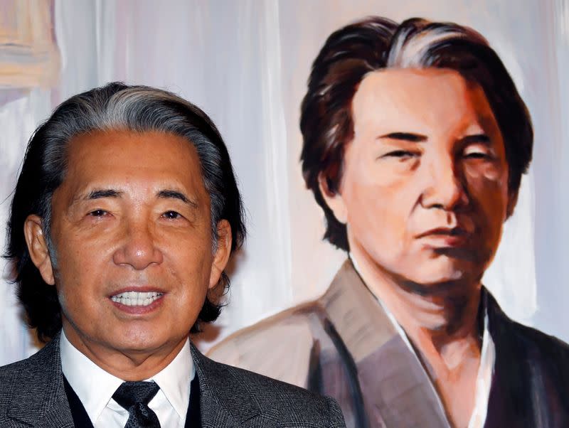 FILE PHOTO: Japanese fashion designer Kenzo Takada poses next to a painting of his self-portrait offered to the "Fight Aids" foundation gala auction on World AIDS Day in Monaco