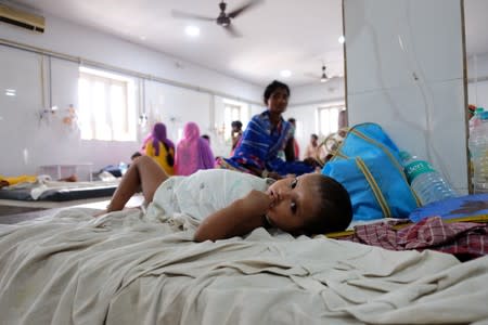 Child suffering from acute encephalitis syndrome lies on a bed at a hospital in Muzaffarpur