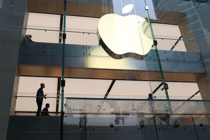 Customers and staff wear protective masks inside an Apple Store in Sydney