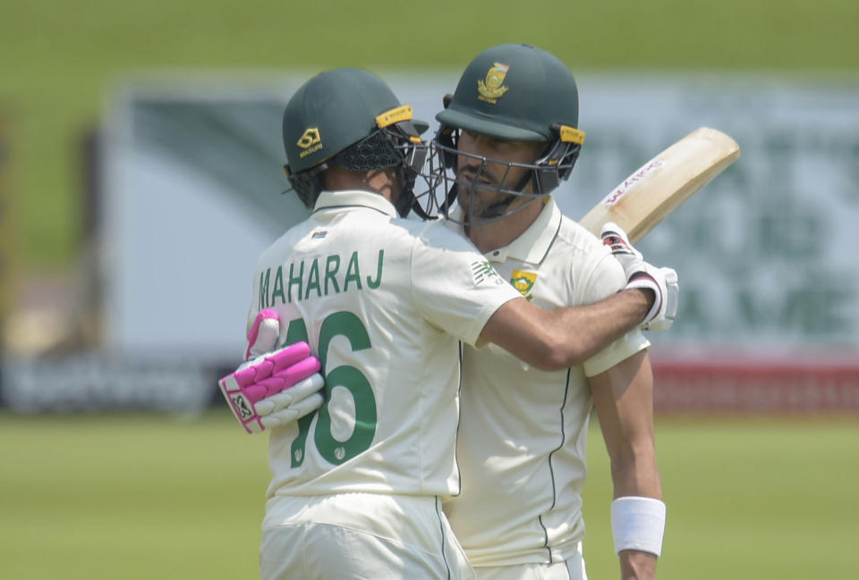 South Africa's Faf du Plessis reaches 150 and is embraced by teammate Keshav Maharaj, on day three of the first cricket test match between South Africa and Sri Lanka at Super Sport Park Stadium in Pretoria, South Africa, Monday, Dec. 28 2020. (AP Photo/Catherine Kotze)