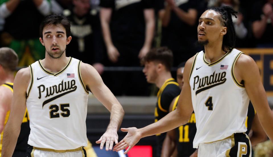 Purdue Boilermakers guard Ethan Morton (25) and Purdue Boilermakers forward Trey Kaufman-Renn (4) high-five during the NCAA men’s basketball game against the Iowa Hawkeyes, Monday, Dec. 4, 2023, at Mackey Arena in West Lafayette, Ind.