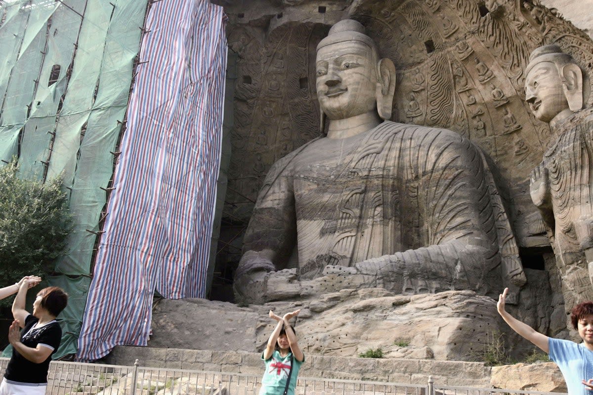 File Visitors view Buddhist sculptures at the Yungang Grottoes on 6 August 2006 in Datong of Shanxi Province, China (Getty Images)