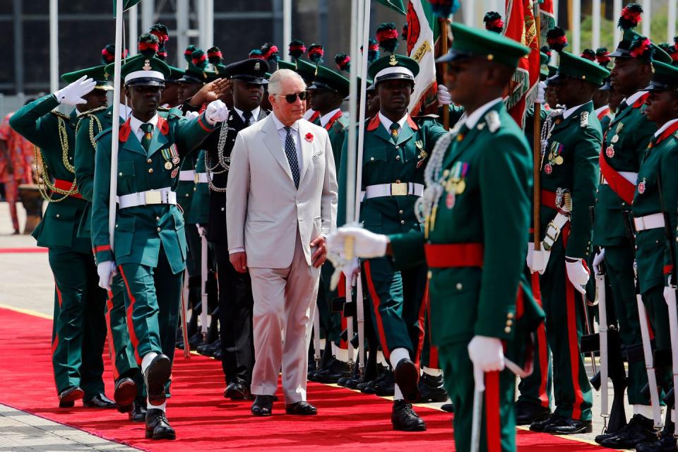 <p>Upon his arrival in Nigeria, Prince Charles reviews an honor guard of Nigerian troops at a ceremony. This is the last country Charles and Camila will visit on their eight-day West African tour. </p>