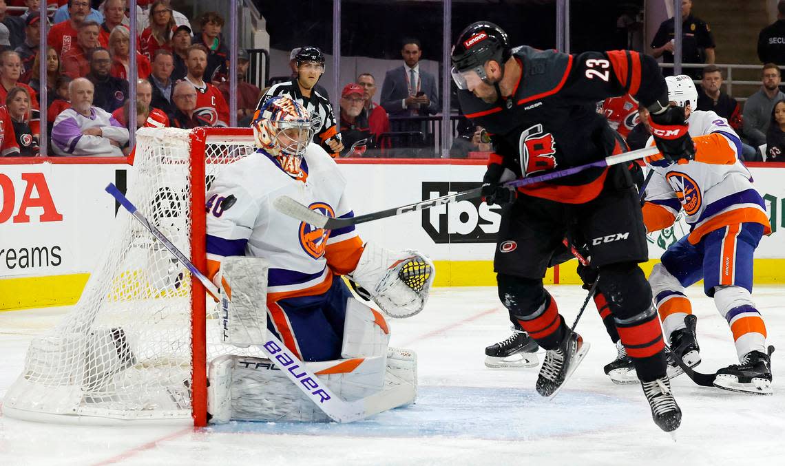 Carolina right wing Stefan Noesen (23) watches as the shot by Evgeny Kuznetsov prepares to go past New York goaltender Semyon Varlamov (40) to score in the first period of the Hurricanes game against the Islanders in the first round of the Stanley Cup playoffs at PNC Arena in Raleigh, N.C., Saturday, April 20, 2024.