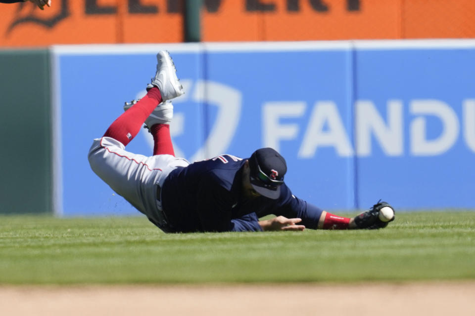 Boston Red Sox center fielder Adam Duvall loses the ball on a Detroit Tigers' Spencer Torkelson fly ball in the ninth inning of a baseball game in Detroit, Sunday, April 9, 2023. Duvall was injured on the play and left the game. (AP Photo/Paul Sancya)
