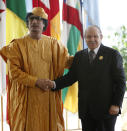 FILE - In this July 1, 2009 file photo, Libyan leader Moammar Gadhafi, left receives Algerian President Abdelaziz Bouteflika ahead of the opening session of the 13th African Union summit of heads of state and government in Sirte, Libya. Former Algerian President Bouteflika, who fought for independence from France in the 1950s and 1960s and was ousted amid pro-democracy protests in 2019 after 20 years in power, has died at age 84, state television announced Friday, Sept. 17, 2021. (AP Photo/Nasser Nasser, File)