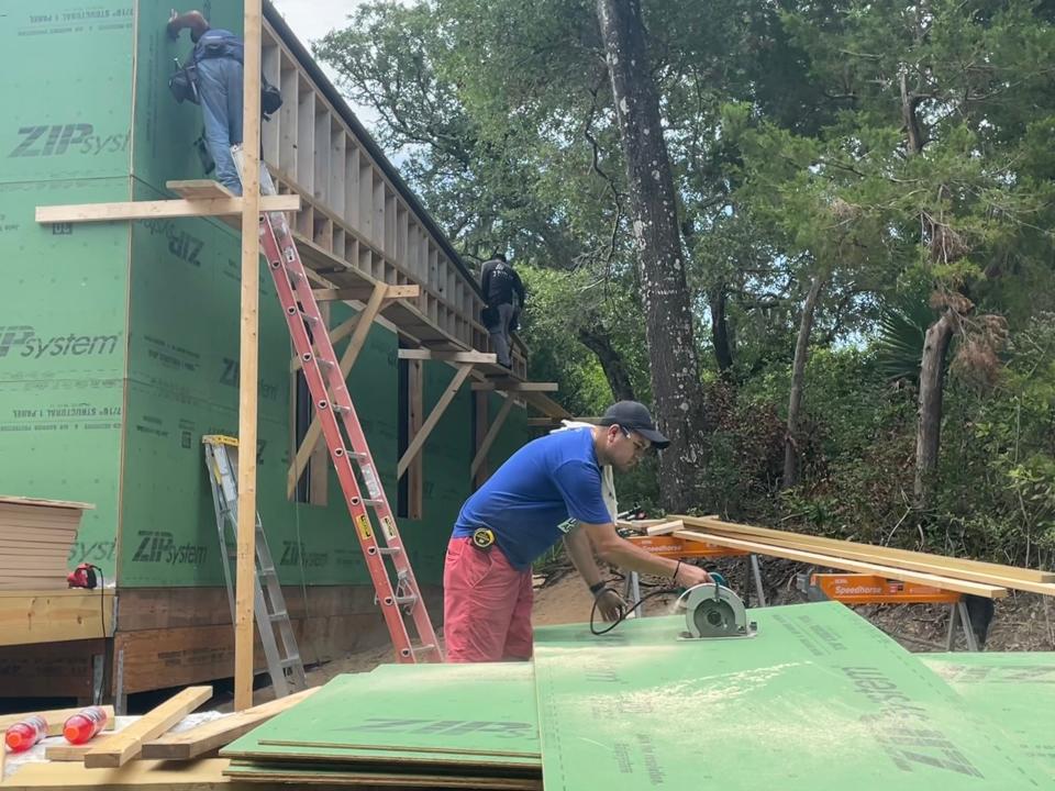Construction workers build the commercial space where Bald Head Island Academy will be located.