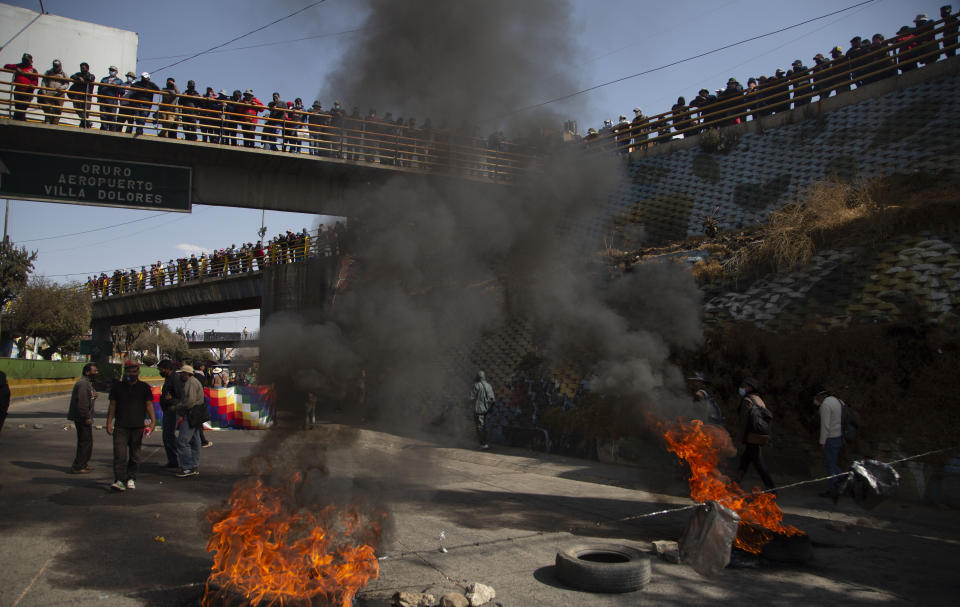 FILE - In this Aug. 10, 2020 file photo, demonstrators burn tires to protest the postponement of the upcoming presidential election in El Alto, Bolivia. Citing the ongoing new coronavirus pandemic, the nation's highest electoral authority delayed presidential elections from Sept. 6 to Oct. 18, the third time the vote has been delayed. (AP Photo/Juan Karita, File)