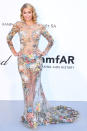 The heiress glowed on the gray-carpet wearing a sheer floral-embroidered Nicolas Jebran gown at the amfAR Gala in May 2018 Cannes, France.