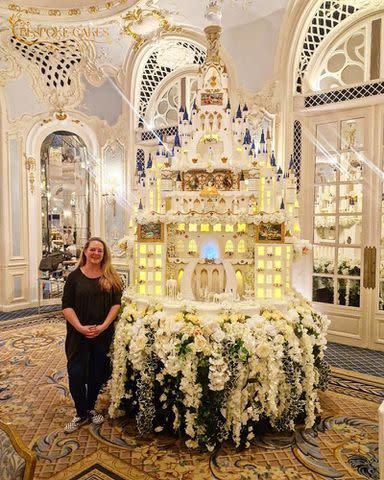<p>David Woodruff for Bespoke Cakes by Sam</p> Cake artist Sam Woodruff poses with her castle masterpiece at the Savoy in London