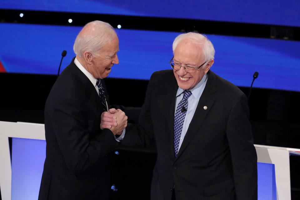 Former Vice President Joe Biden greets Sen. Bernie Sanders before the Democratic presidential primary debate at Drake University on Jan. 14, 2020 in Des Moines, Iowa.