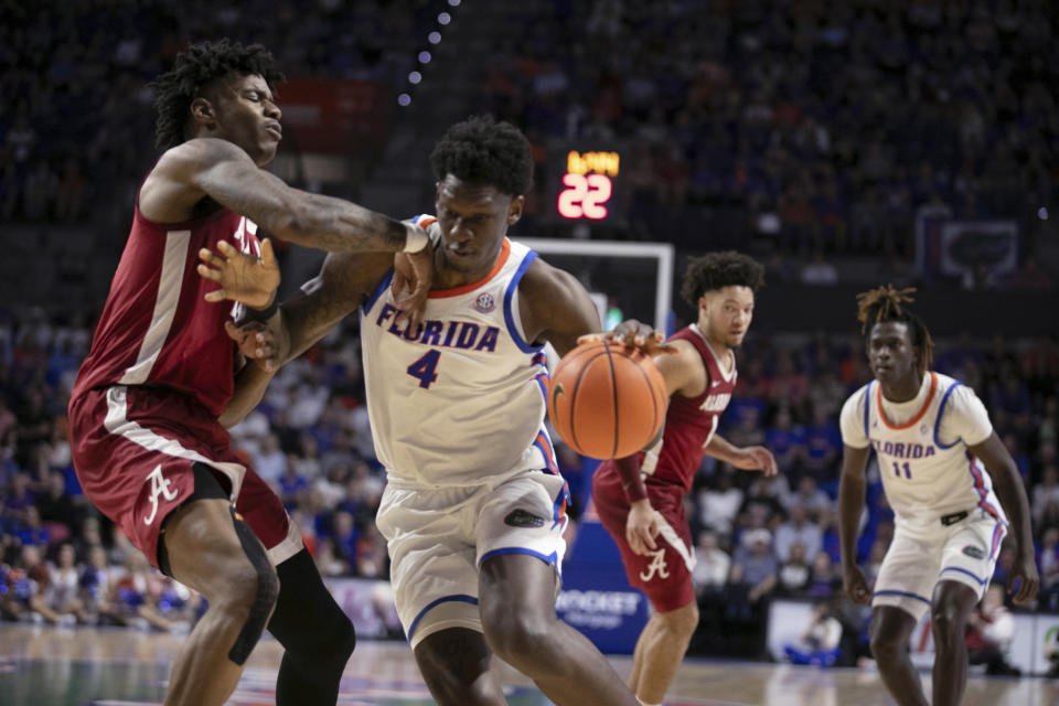 Florida forward Tyrese Samuel (4) drives against Alabama forward Nick Pringle during the first half of an NCAA college basketball game Tuesday, March 5, 2024, in Gainesville, Fla. (AP Photo/Alan Youngblood)