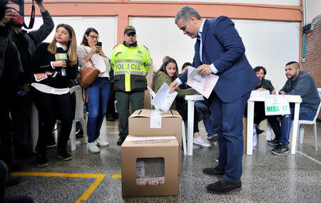 Ivan Duque, presidential candidate of the party Centro Democratico, casts his vote during the legislative elections in Bogota, Colombia March 11, 2018. REUTERS/Carlos Julio Martinez