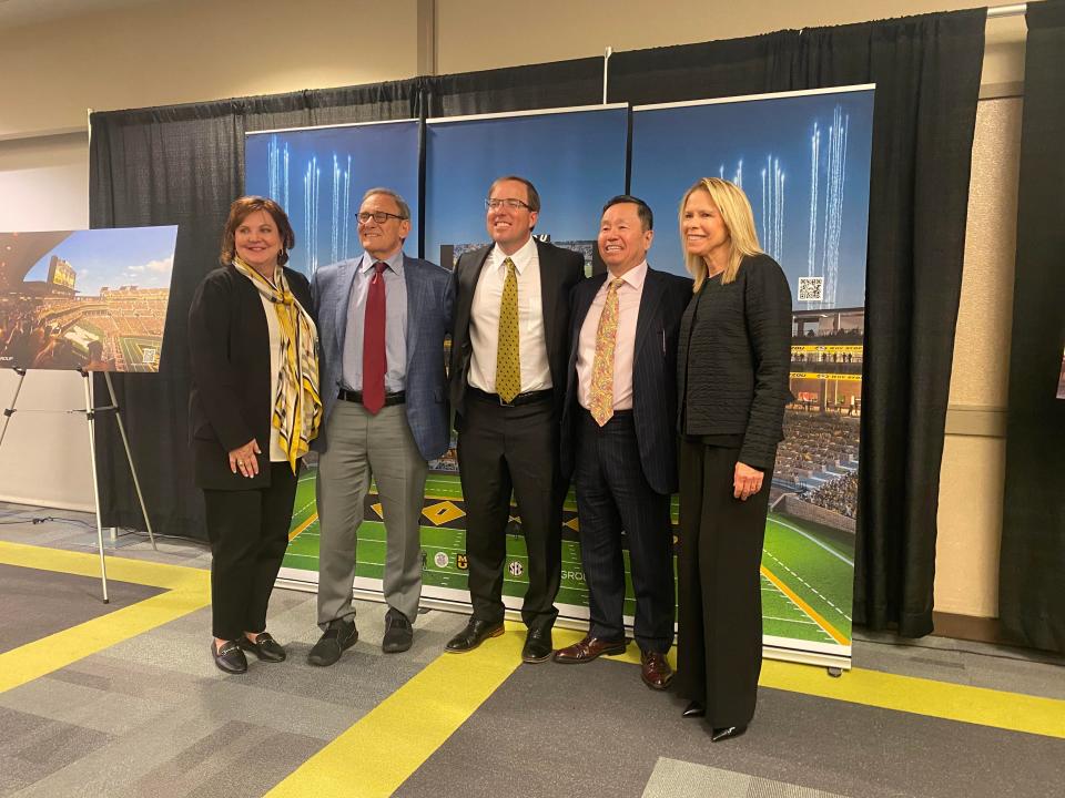 From left: UM Board of Curators chair Robin Wenneker, curator Bob Blitz, Missouri football coach Eli Drinkwitz, UM System President Mun Choi and interim athletic director Marcy Girton stand Thursday in Rolla, Missouri, in front of a rendering of the approved renovation to Memorial Stadium.