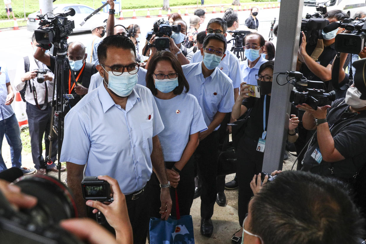 Workers' Party Secretary-General Pritam Singh, left, and Chairman Sylvia Lim, second left, arrive at a nomination center with their team to submit their nomination papers ahead of the general election in Singapore, Tuesday, June 30, 2020. Campaigning has begun for Singapore’s general elections, with the opposition hoping to dent the ruling party’s supermajority in parliament. (AP Photo/Yong Teck Lim)