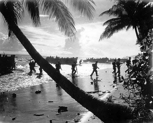 U.S. troops from the 160th Infantry Regiment are seen as they disembark from a landing craft during amphibious training on Guadalcanal, Solomon Islands, in March 1942.