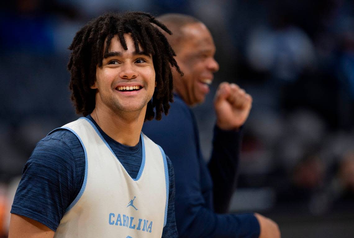 North Carolina’s Elliot Cadeau (2) smiles after an exchange with coach Hubert Davis during their practice on Wednesday, March 20, 2024 as they prepare for the NCAA Tournament at Spectrum Center in Charlotte, N.C. Robert Willett/rwillett@newsobserver.com