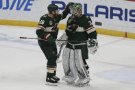 Minnesota Wild's Ian Cole (28) celebrates with goalie Kaapo Kahkonen (34) after their win over the Vegas Golden Knights in an NHL hockey game Monday, March 8, 2021, in St. Paul, Minn. (AP Photo/Stacy Bengs)