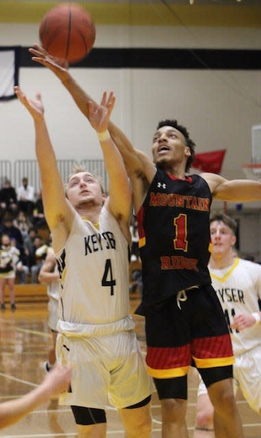 Jacob Weinrich of Keyser and Amare Kennedy of Mountain Ridge jump for a rebound. Kennedy scored 16, and Weinrich three points, as Mountain Ridge claimed the 61-47 victory.