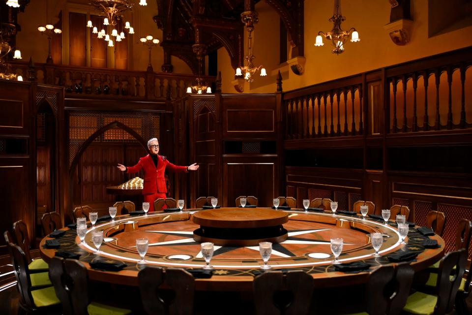 Empty Round table room with Alan Cumming standing in front of it on The Traitors US