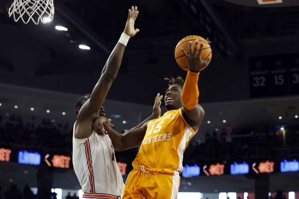 Tennessee guard Jahmai Mashack (15) puts up a shot over Auburn forward Johni Broome (4) during the first half of an NCAA college basketball game Saturday, March 4, 2023, in Auburn, Ala. (AP Photo/Butch Dill)
