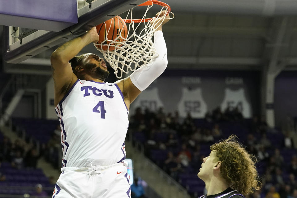TCU center Eddie Lampkin Jr. (4) dunks in front of Central Arkansas guard Elias Cato during the first half of an NCAA college basketball game in Fort Worth, Texas, Wednesday, Dec. 28, 2022. (AP Photo/LM Otero)