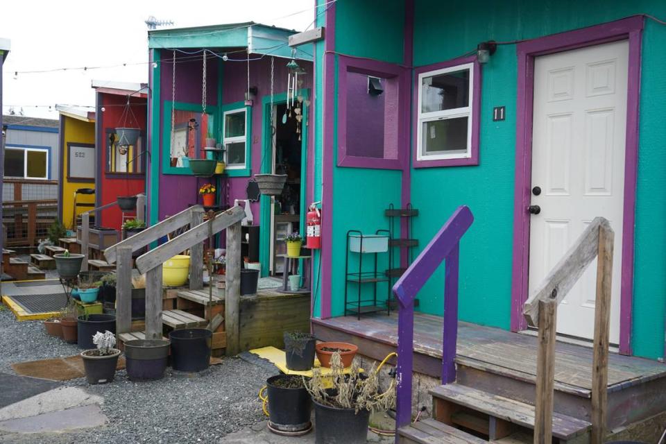 Decorations and plants adorn the outside of some tiny homes at Unity Village on April 20, 2023, in Bellingham, Wash. The nonprofit HomesNOW! opened Unity Village in 2019 as the city’s first tiny home village for homeless individuals.