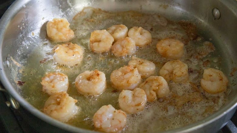 fully cooked shrimp in a metal skillet