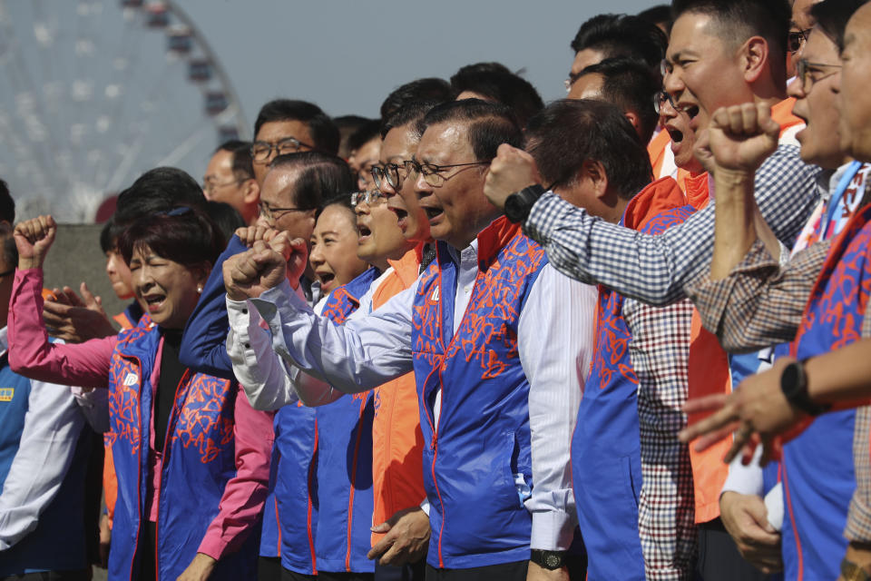 In this photo taken Thursday, Nov. 21, 2019, Members of the pro-government Democratic Alliance for the Betterment and Progress of Hong Kong, gestures during an event ahead of the upcoming district elections held in Hong Kong in Hong Kong. Pro-government candidates admit they are the underdogs amid public fury but are urging voters to choose stability over violence in their pursuit of democracy. (AP Photo/Ng Han Guan)